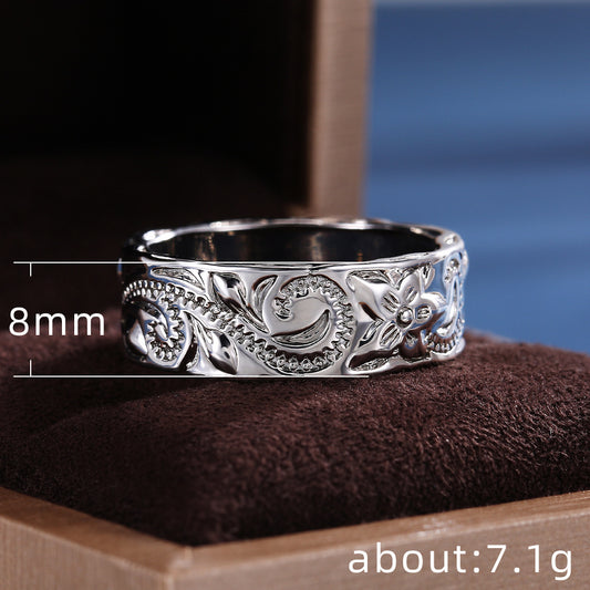 Silver ring with floral design on a brown cushion, with measurements displayed.