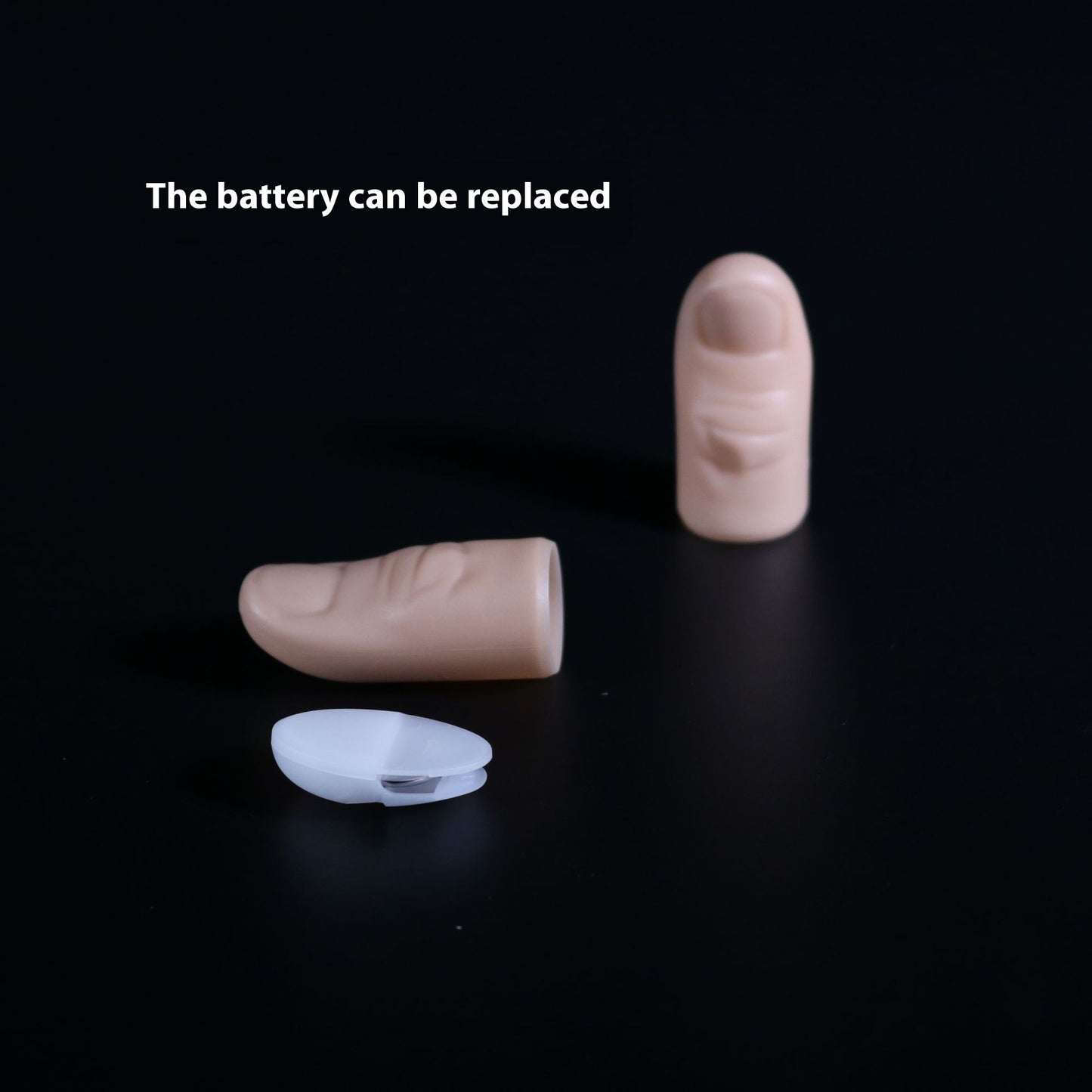 Two beige hearing aid batteries and a clear battery case on a black background with text 'The battery can be replaced'.