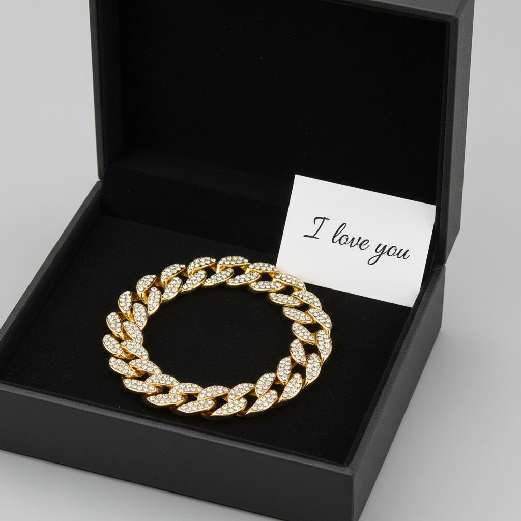 Gold chain bracelet with clear gemstones on a white background