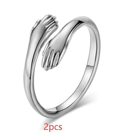 Silver ring with hand design on a white background