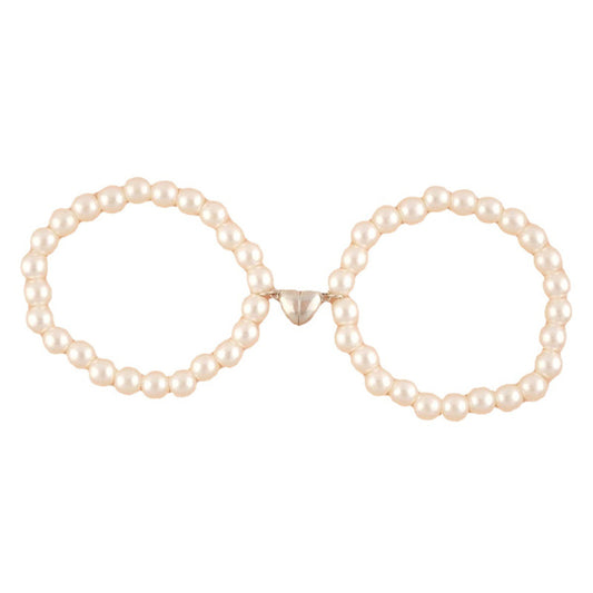 Pair of pearl hoop earrings on a white background
