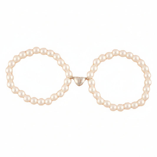 Pair of pearl hoop earrings on a white background