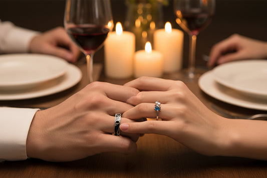 Two silver rings with gemstones on a man and woman