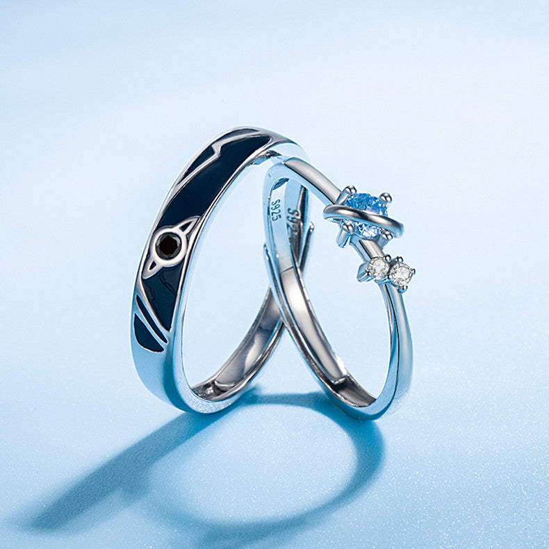 Two silver rings with gemstones on a light blue background