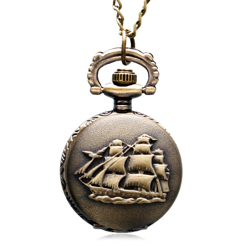 Bronze pocket watch with ship design on a white background