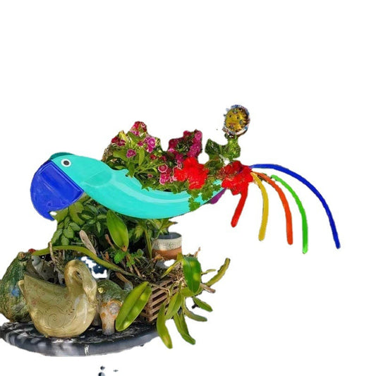 Colorful glass sculpture of a bird with plants and a duck on a white background