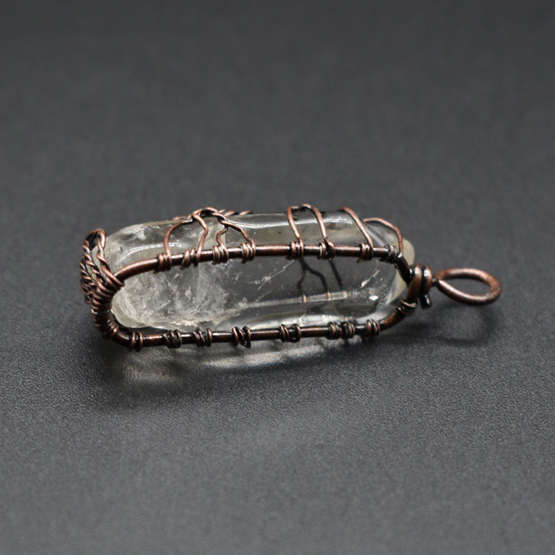 Crystal pendant with copper wire wrapping on a dark gray background