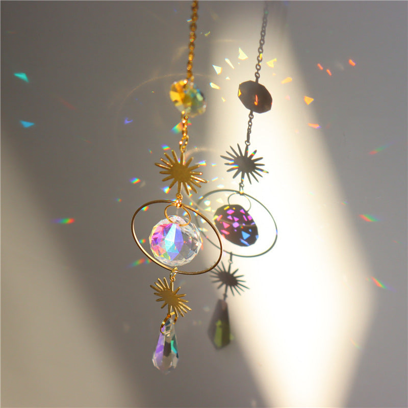 Decorative hanging crystal with rainbow effect on a gray background