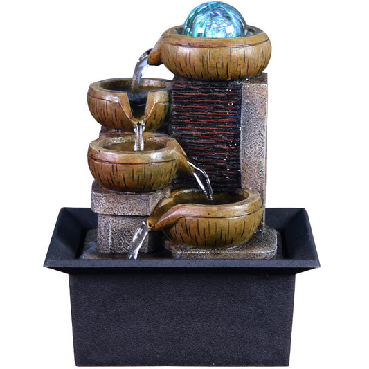 Decorative water fountain with tiered bowls and a glowing ball on a white background