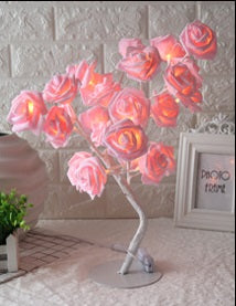 Decorative lamp with pink flowers on a white surface