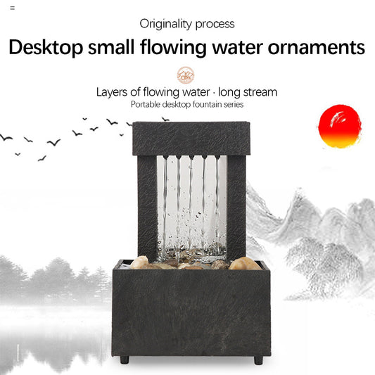 Desktop water fountain with flowing water on a white background