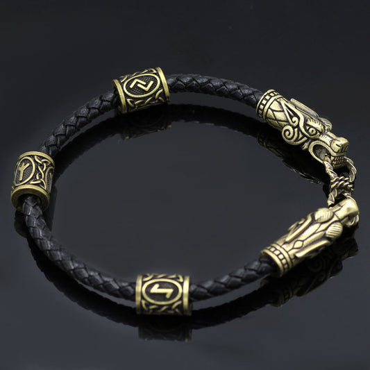 Black braided leather bracelet with gold dragon head clasp on a dark background