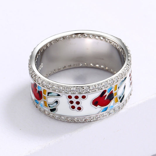 Silver ring with colorful designs on a white background