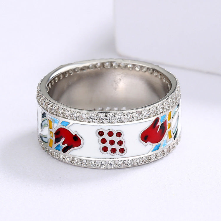 Silver ring with colorful designs on a white background