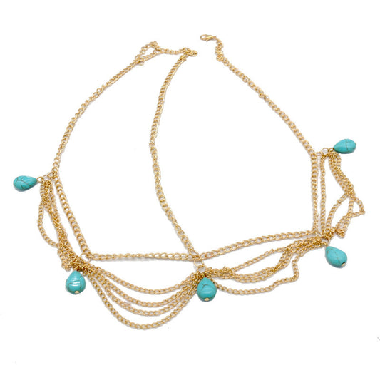 Gold necklace with turquoise beads on a white background