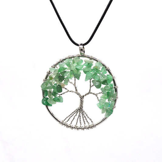 Necklace with a green gemstone tree of life pendant on a white background
