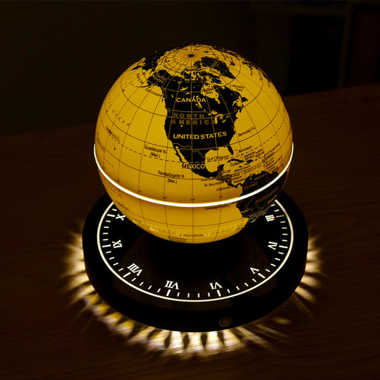 Yellow world globe with a dark base on a reflective surface