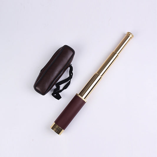 Gold and brown telescopic baton with carrying case on a light gray background