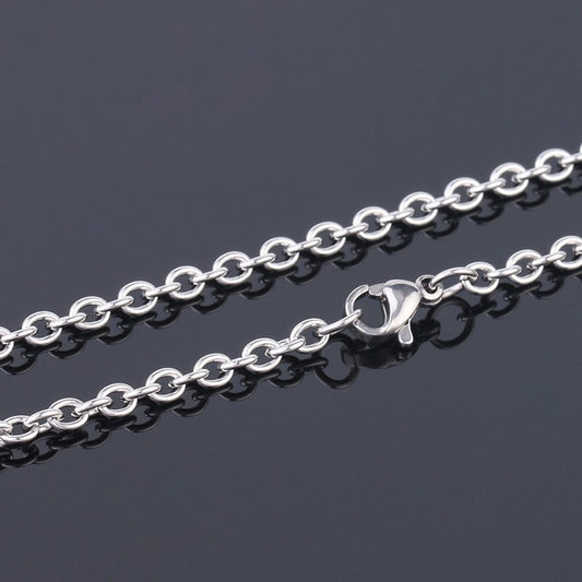 Silver chain necklace on a dark background