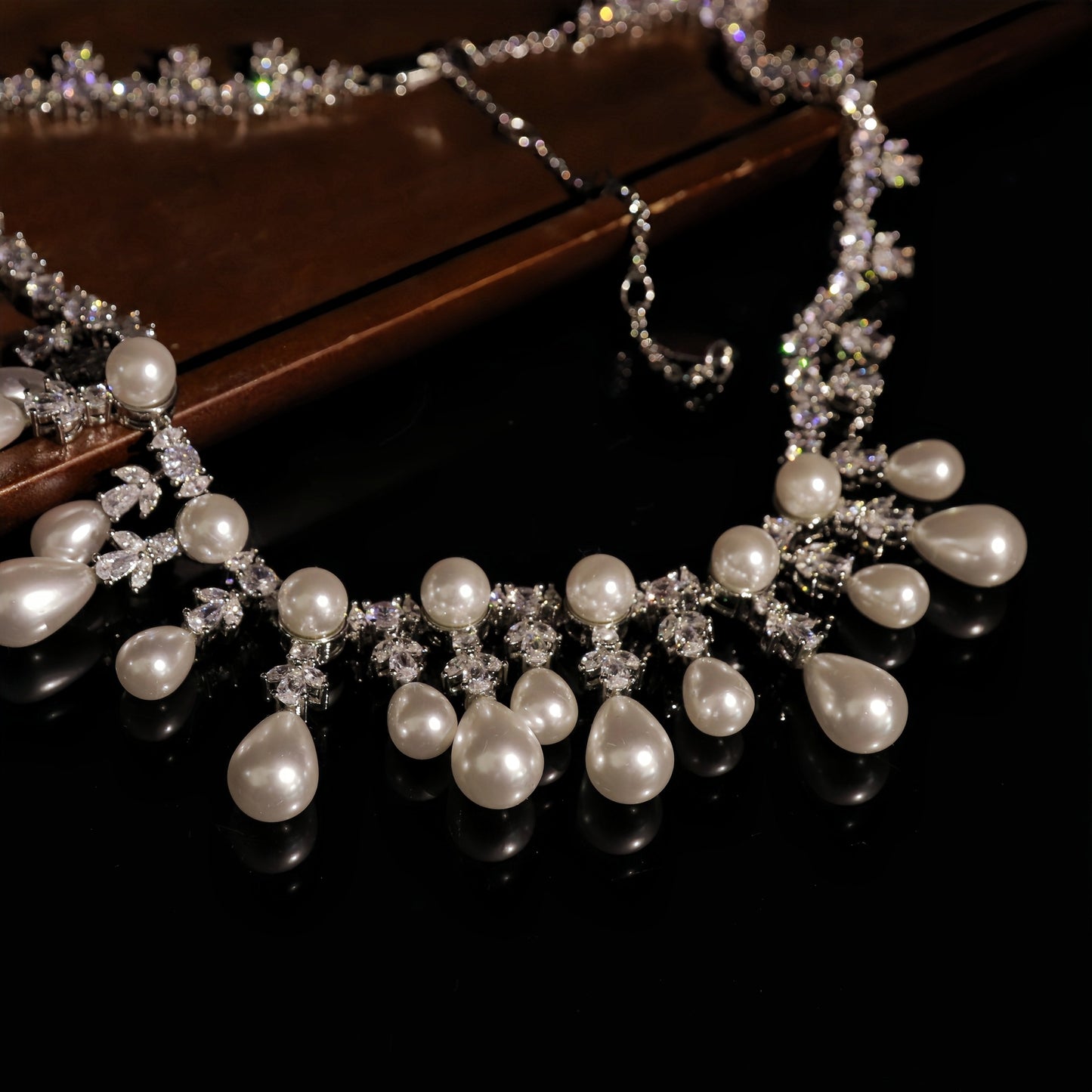 Pearl necklace with crystal accents on a dark surface