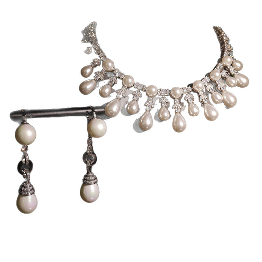Pearl and crystal necklace on a white background