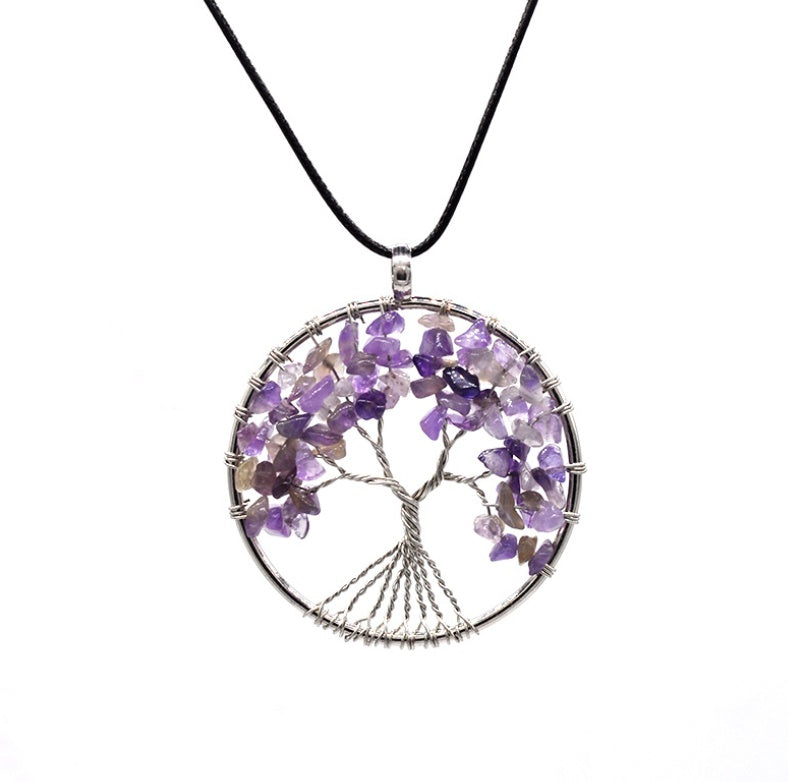 Tree of Life pendant with purple stones on a white background