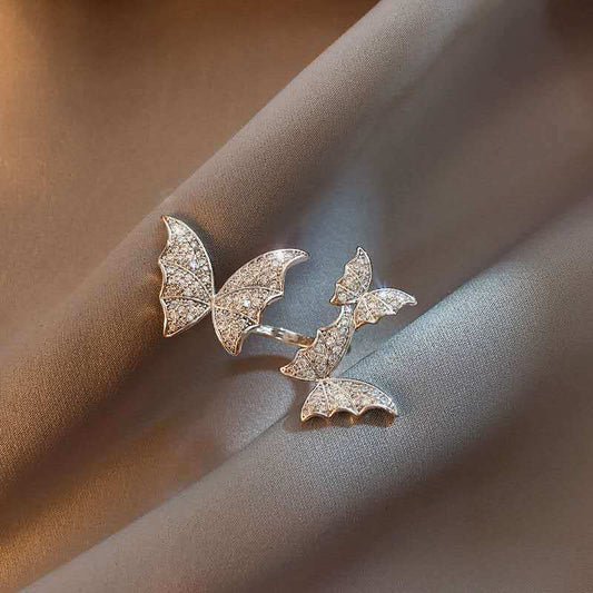 Butterfly-shaped earrings on a soft fabric background