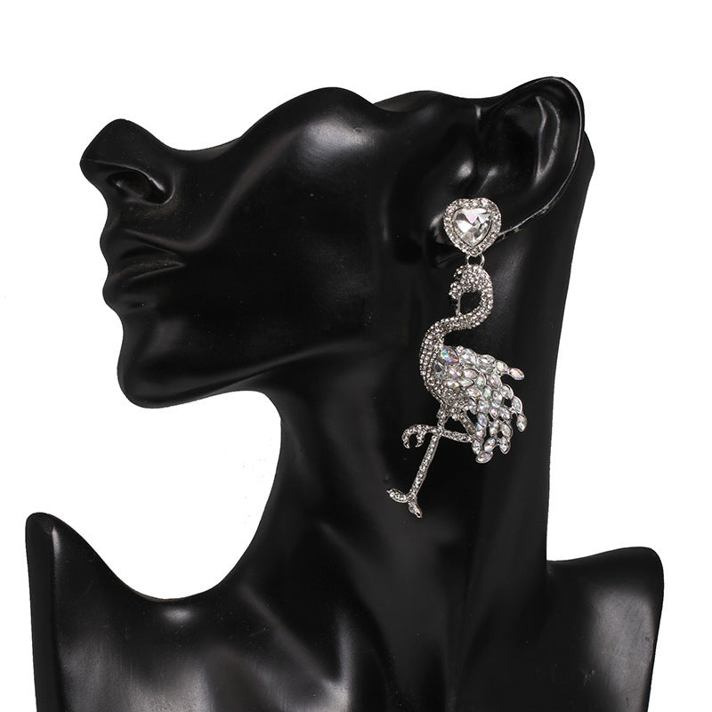 Flamingo-shaped earring on a black mannequin ear