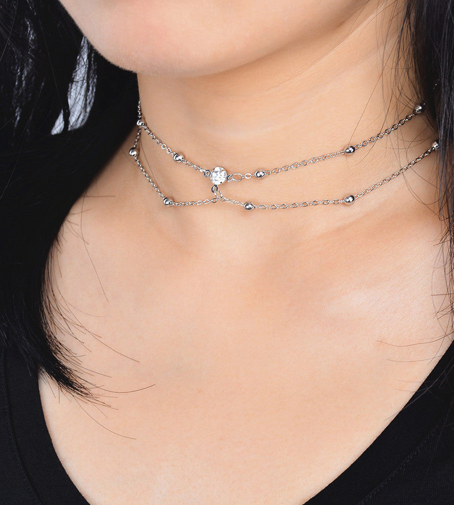 Woman wearing double silver necklace