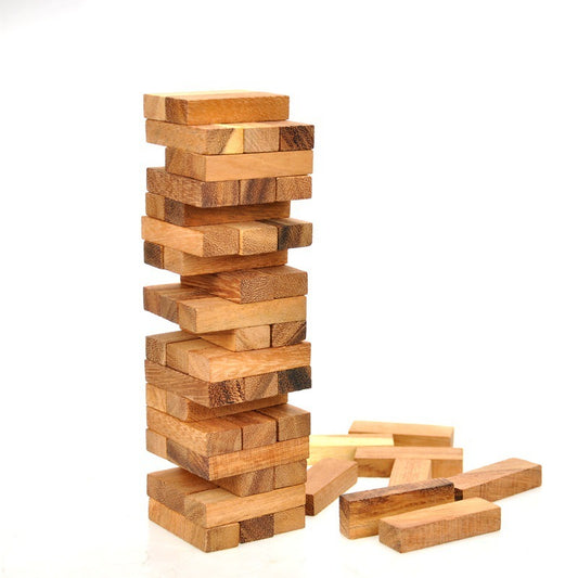 Wooden block tower game with additional blocks on a white background