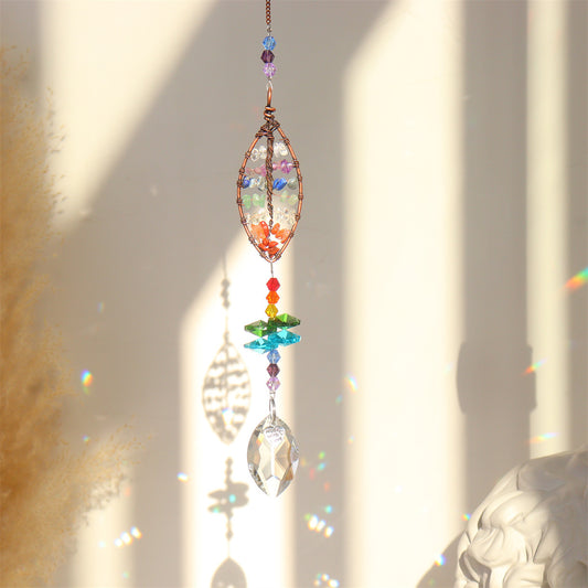 Colorful crystal hanging ornament with rainbow beads against a light background
