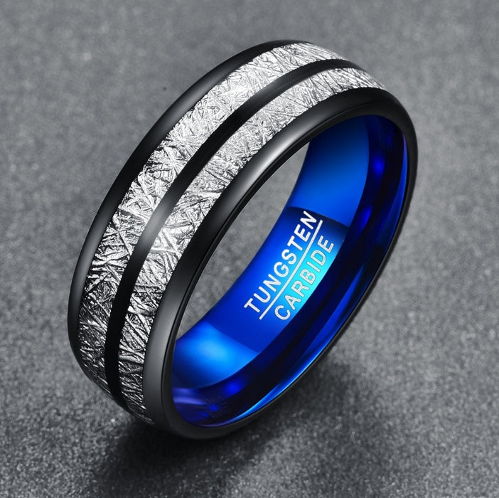 Tungsten carbide ring with blue interior and textured exterior on a gray background