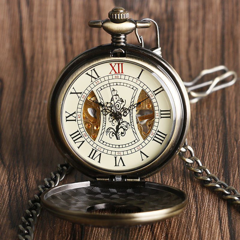 Vintage pocket watch with intricate design on a wooden background