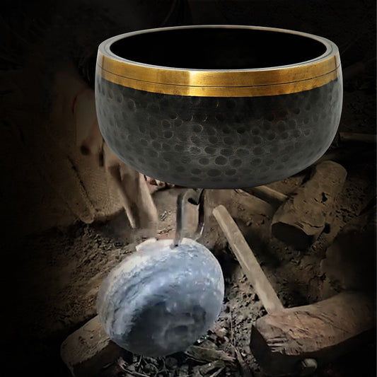 Decorative meditation bowl with gold rim on a dark background