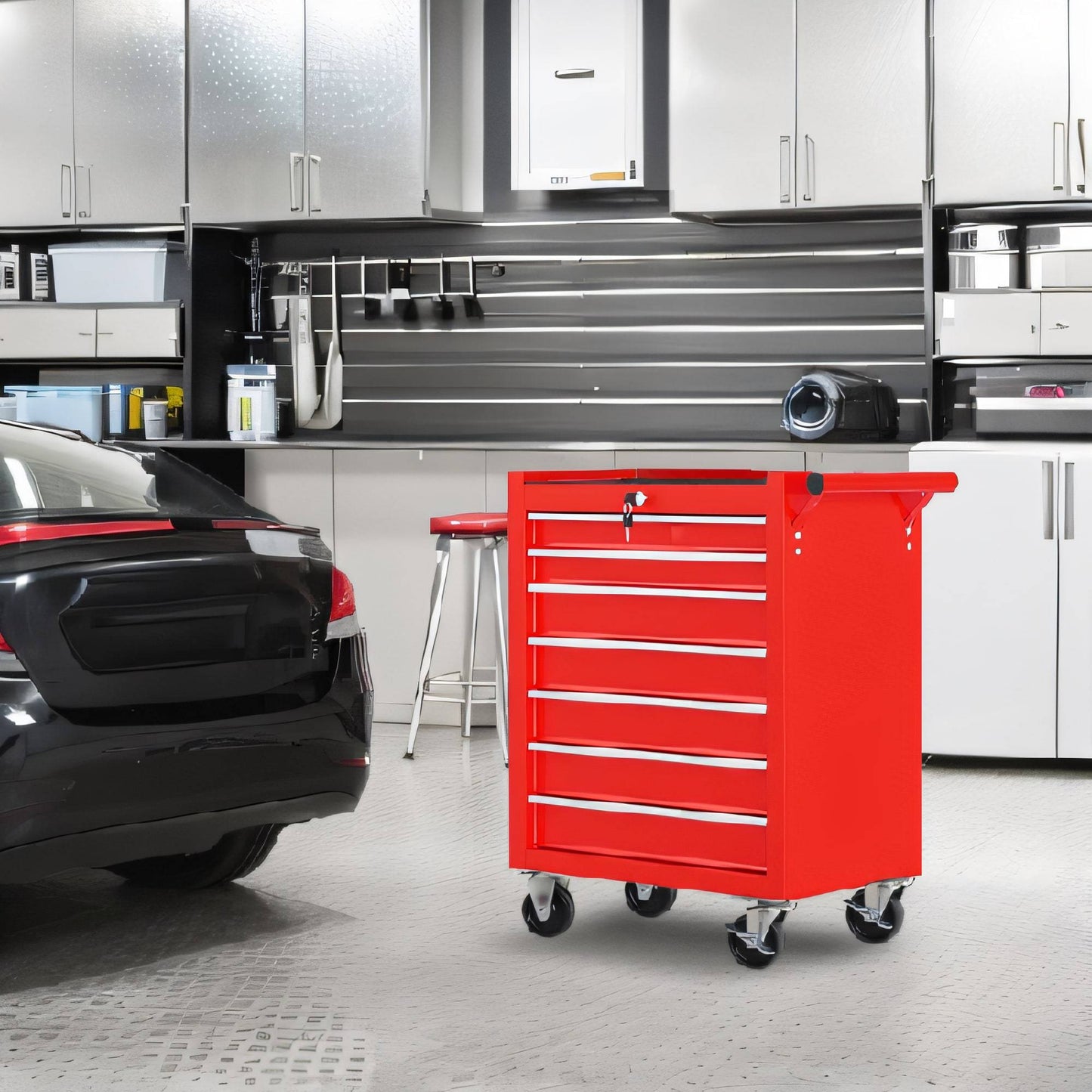 Red tool cart in a garage with a car and cabinets in the background