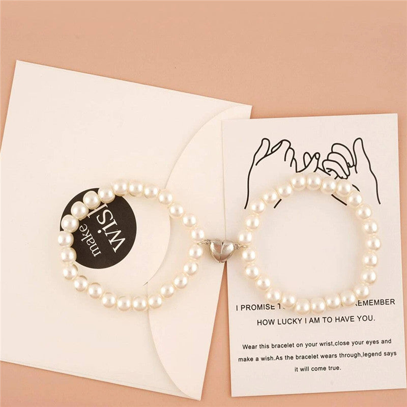 Pearl bracelet with a card on a beige background