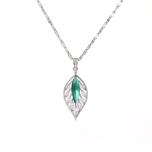 Silver necklace with a green gemstone pendant on a white background