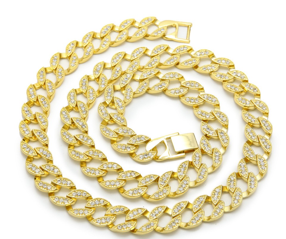 Gold chain necklace with clear stones on a white background