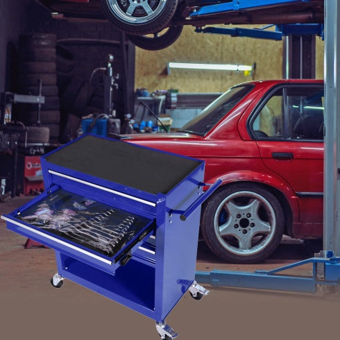 Blue tool cart with open drawer in a garage setting with a red car.