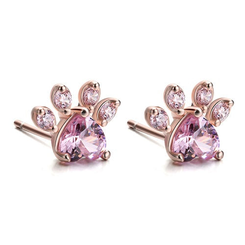 Pair of pink gemstone earrings with rose gold setting on a white background