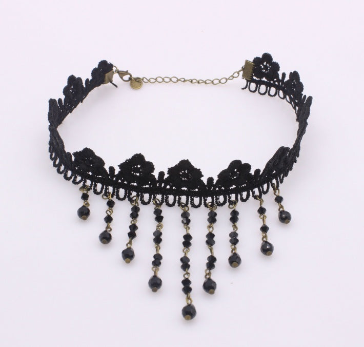 Black lace choker necklace with beads on a white background