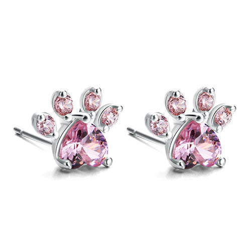Pair of earrings with pink gemstones on a white background