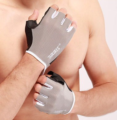 Person wearing a gray fitness glove with black accents on a plain background