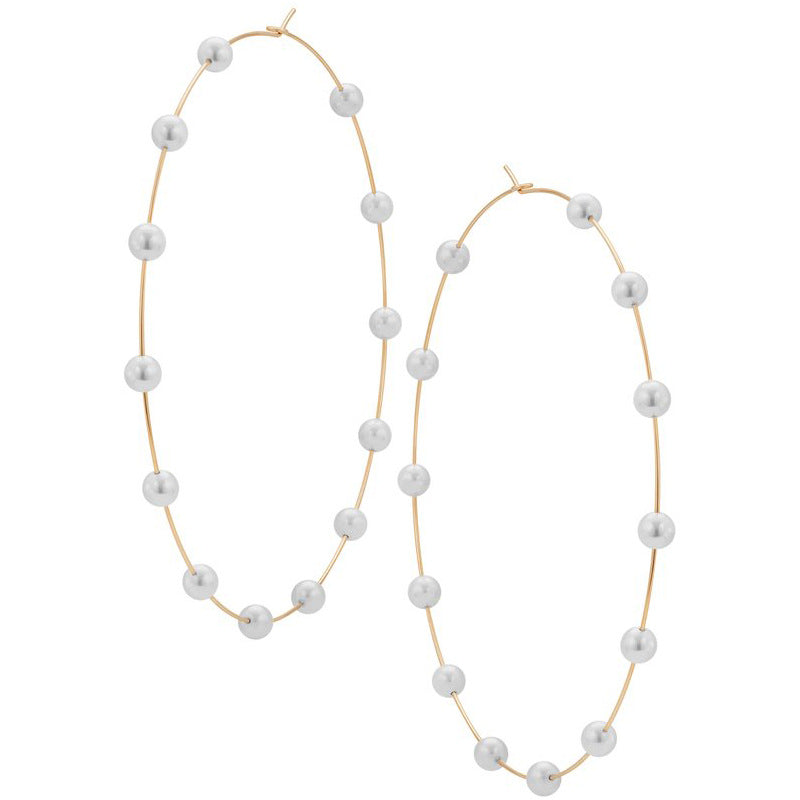 Long pearl necklace with gold chain on a white background