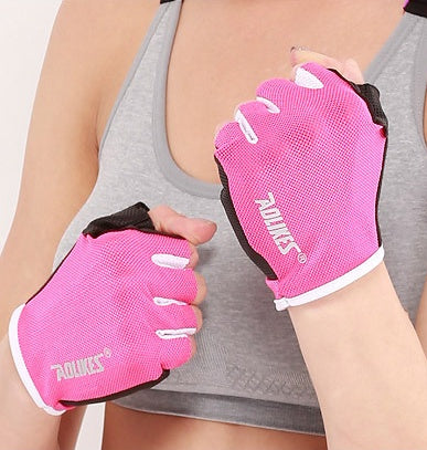 Person wearing pink five-finger gloves with black and white accents on a neutral background