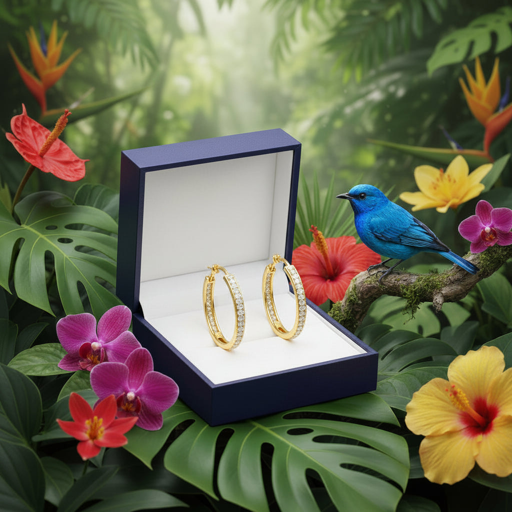 Gold hoop earrings with embedded stones in gift box with bluebird in garden