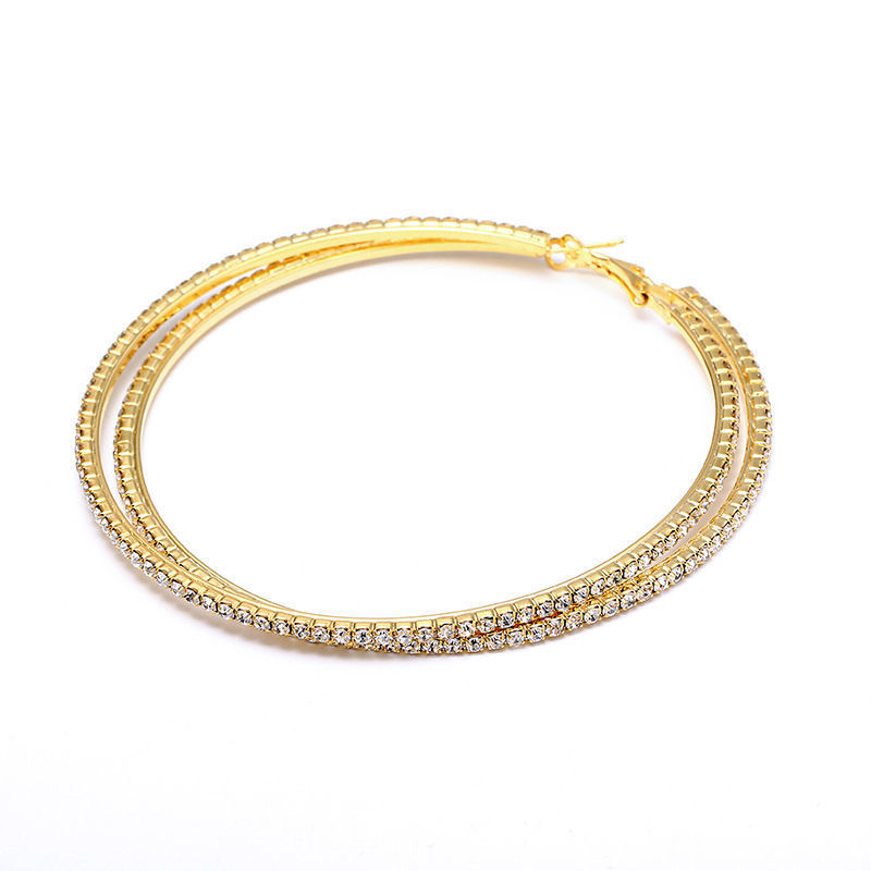 Gold hoop earrings with embedded stones on a white background