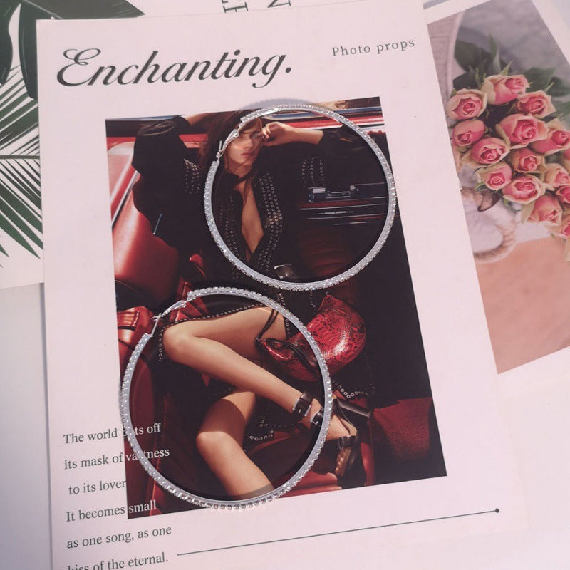 Product display with 'Enchanting' text and circular photo props.