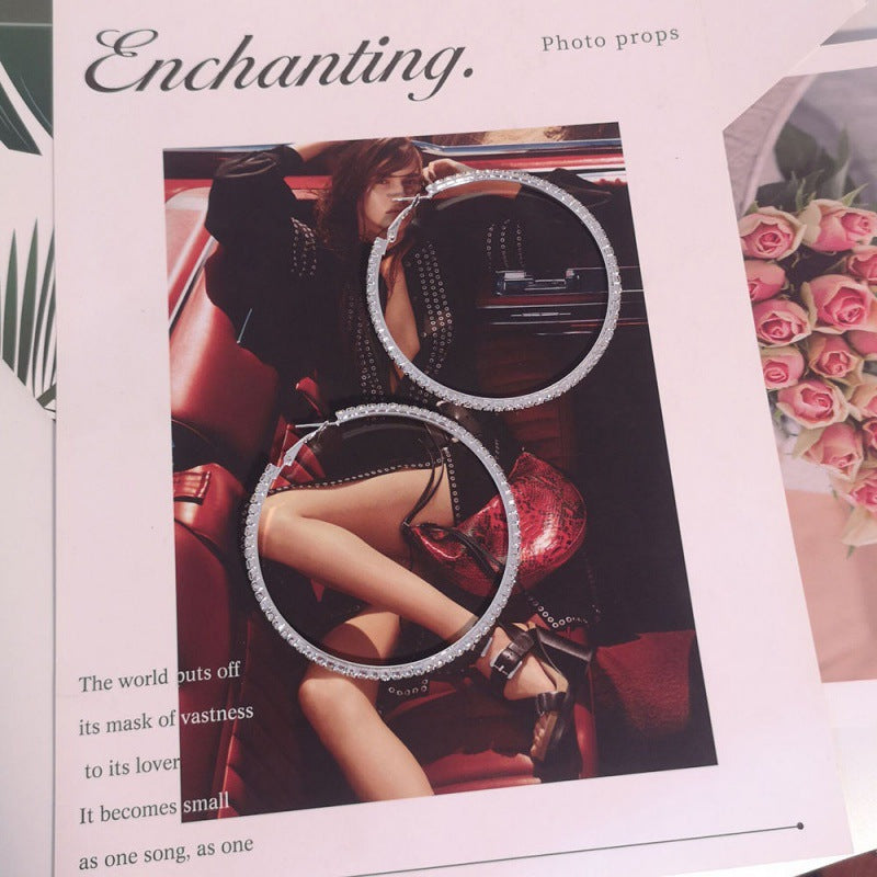 Magazine page with a photo of a person in a car, surrounded by decorative elements.