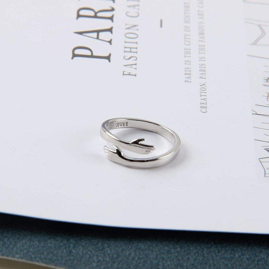 Silver ring on a magazine with text